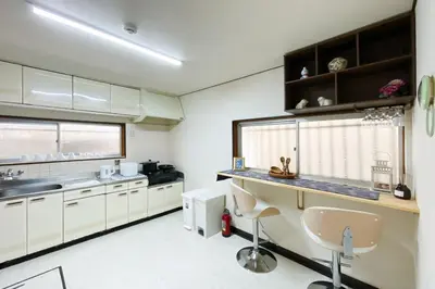 a kitchen with white cabinets and a counter top at New Super Deals Now Available Direct Access to Akihabara Shinjuku and Disneyland in Tokyo