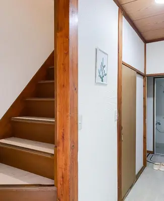 an empty staircase in a room with a door at New Super Deals Now Available Direct Access to Akihabara Shinjuku and Disneyland in Tokyo