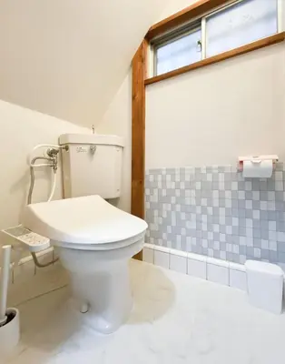 a bathroom with a white toilet and a window at New Super Deals Now Available Direct Access to Akihabara Shinjuku and Disneyland in Tokyo