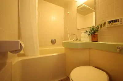 a bathroom with a white toilet and a sink at \u30b9\u30bf\u30fc\u30cf\u30a4\u30c4\u84b2\u7530 in Tokyo
