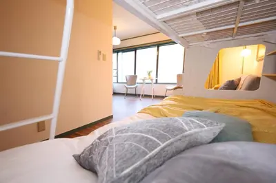 a bedroom with a bed and a mirror at \u30b9\u30bf\u30fc\u30cf\u30a4\u30c4\u84b2\u7530 in Tokyo