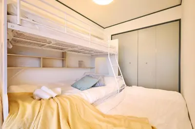 a small bedroom with a bunk bed in it at \u30b9\u30bf\u30fc\u30cf\u30a4\u30c4\u84b2\u7530 in Tokyo