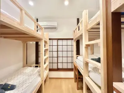 a dorm room with four bunk beds in it at \u6771\u4eac\u4e2d\u5fc3\u5c0f\u578b\u522b\u5885 in Tokyo