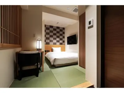 a bedroom with a bed and a checkerboard wall at Prostyle Ryokan Tokyo Asakusa - Vacation STAY 48261v in Tokyo