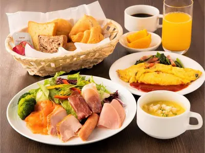 a table with plates of food and cups of orange juice at Prostyle Ryokan Tokyo Asakusa - Vacation STAY 48261v in Tokyo