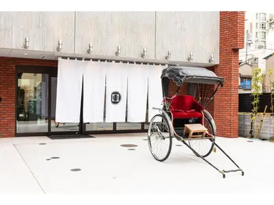 a red rickshaw parked in front of a building at Prostyle Ryokan Tokyo Asakusa - Vacation STAY 48265v in Tokyo
