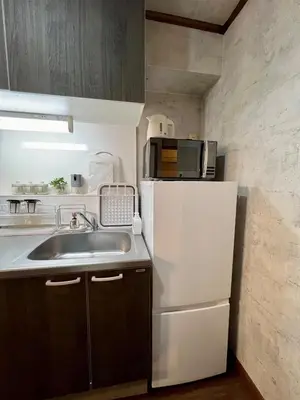 a kitchen with a sink and a white refrigerator at Vista Ikegami 202 - Vacation STAY 17403 in Tokyo