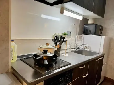 a kitchen with a stove with a pot on it at Vista Ikegami 202 - Vacation STAY 17403 in Tokyo