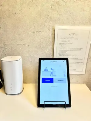 a tablet sitting on a desk next to a cup at Vista Ikegami 202 - Vacation STAY 17403 in Tokyo