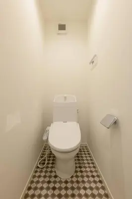 a bathroom with a white toilet in a room at Rakuna Inn \u52d5 Sasazuka in Tokyo