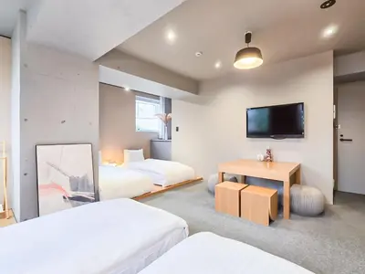 a hotel room with two beds and a flat screen tv at STAY ARI Shinjuku Takadanobaba Design awarded in Tokyo