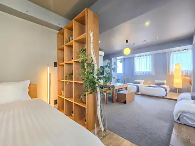a bedroom with a bed and a desk with a table at STAY ARI Shinjuku Takadanobaba Design awarded in Tokyo