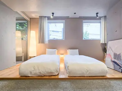 two beds in a room with two windows at STAY ARI Shinjuku Takadanobaba Design awarded in Tokyo