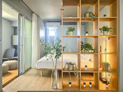 a room with a book shelf filled with potted plants at STAY ARI Shinjuku Takadanobaba Design awarded in Tokyo