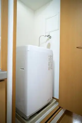a kitchen with a white refrigerator in a room at \u65b0\u5c0f\u5ca9\u30c7\u30e1\u30c6\u30eb303 in Tokyo