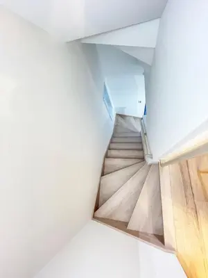 a staircase in a house with white walls and wooden floors at japan house JCA\u99c5\u5f92\u6b693\u5206 \u30f4\u30a3\u30e9\u8cb8\u5207\u304a\u3057\u3083\u308c\u306a\u7a7a\u9593 in Tokyo