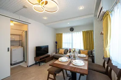 a living room with a dining table and a couch at Asakusa Stay in Tokyo