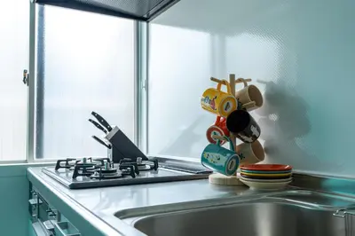 a kitchen counter with a sink and a window at Asakusa Stay in Tokyo