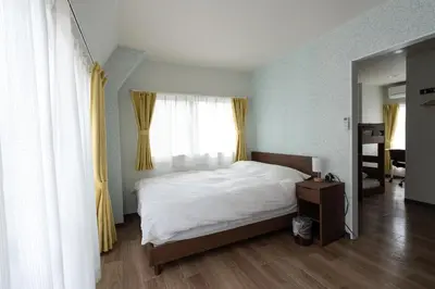 a bedroom with a white bed and a window at Asakusa Stay in Tokyo