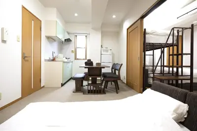 a room with a bed and a table and a kitchen at Swan Lake Inn Shinjuku Room 501 - Vacation STAY 16588 in Tokyo
