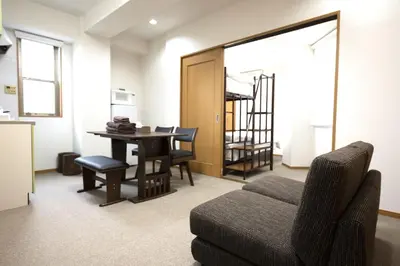 a living room with a couch and a table at Swan Lake Inn Shinjuku Room 501 - Vacation STAY 16588 in Tokyo