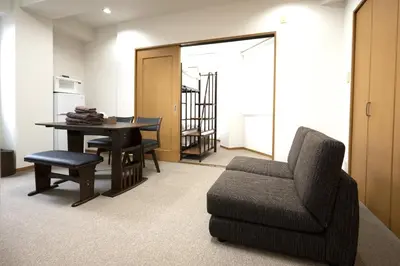 a living room with a chair and a table at Swan Lake Inn Shinjuku Room 501 - Vacation STAY 16588 in Tokyo