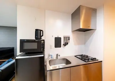 a small kitchen with a sink and a microwave at BH Terace 102 - Vacation STAY 17368 in Tokyo