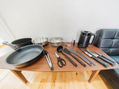 a table with utensils and a frying pan on it at BH Terace 102 - Vacation STAY 17368 in Tokyo