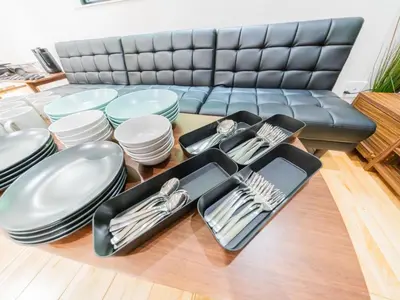 a table with plates and utensils and a couch at BH Terace 102 - Vacation STAY 17368 in Tokyo