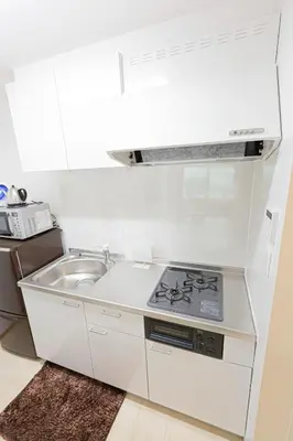 a white kitchen with a stove and a sink at A to - Vacation STAY 17369 in Tokyo
