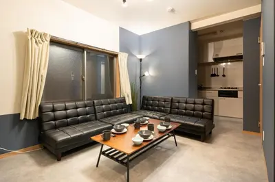 a living room with a leather couch and a table at A to - Vacation STAY 17369 in Tokyo