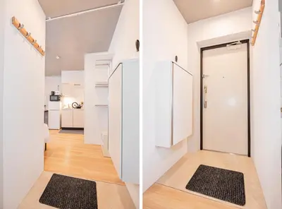 a hallway with white walls and a door with black mats at japan house T-Plaza sugamo in Tokyo