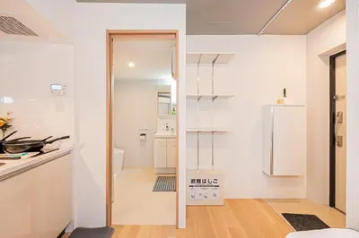 a kitchen with white cabinets and a refrigerator at japan house T-Plaza sugamo in Tokyo