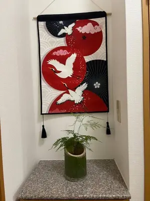 a potted plant sitting on a table with a painting at \u65b0\u5c0f\u5ca9\u99c5\u5f92\u6b693\u5206\u30c7\u30e1\u30c6\u30eb301 in Tokyo