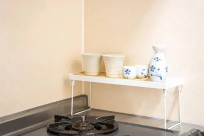 a shelf with three cups and a vase on it at \u65b0\u5c0f\u5ca9\u99c5\u5f92\u6b693\u5206\u30c7\u30e1\u30c6\u30eb301 in Tokyo
