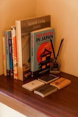 a shelf with a bunch of books on a wall at 70m2 House in central Tokyo in Tokyo