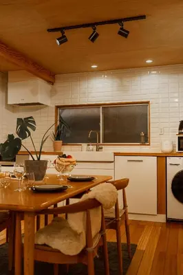 a kitchen with a table with chairs and a blackboard at 70m2 House in central Tokyo in Tokyo