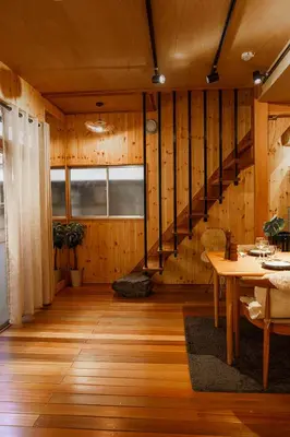 a living room with wooden walls and a staircase at 70m2 House in central Tokyo in Tokyo