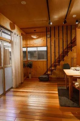 a room with wooden walls and a wooden floor and stairs at 70m2 House in central Tokyo in Tokyo