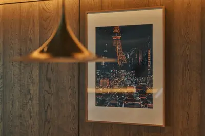 a picture hanging on a wall with a picture of a city at illi Rom Hamamatsucho in Tokyo