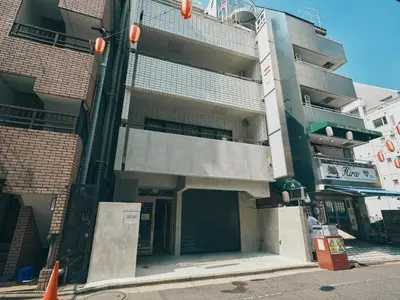 an apartment building with a garage in front of it at illi Rom Hamamatsucho in Tokyo