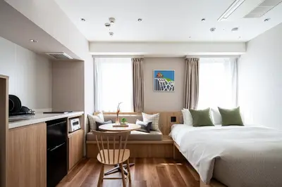 a hotel room with a bed and a small table at Section L Shimbashi West in Tokyo