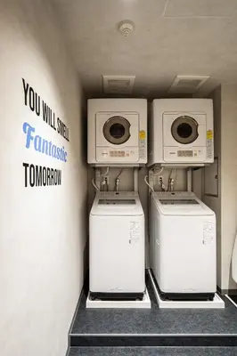 two washing machines and a washer and dryer in a room at Section L Shimbashi West in Tokyo