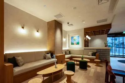 a living room with a couch and tables at Section L Shimbashi West in Tokyo