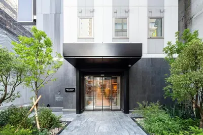 an entrance to a building with a black door at Section L Shimbashi West in Tokyo