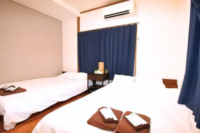 two beds in a hotel room with towels on them at 1棟貸切 宮元 みやげん in 浅草&雷門 - Miyagen in Asakusa&Kaminarimon- 浅草駅徒歩4分 上野や秋葉原までアクセス良好 最大16名 in Tokyo