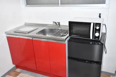 a kitchen with a sink and a microwave at 1棟貸切 宮元 みやげん in 浅草&雷門 - Miyagen in Asakusa&Kaminarimon- 浅草駅徒歩4分 上野や秋葉原までアクセス良好 最大16名 in Tokyo