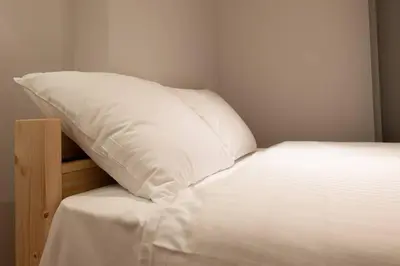 a white pillow sitting on top of a bed at \u30a2\u30f3\u30c9\u30b9\u30c6\u30a4\u6771\u5411\u5cf66\u4e01\u76ee302 Soi house in Tokyo