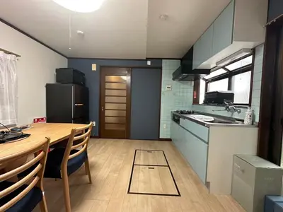 a kitchen with a wooden table and a dining room at West Kamata 5 \u897f\u84b2\u672c\u5bb6 in Tokyo