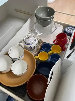 a drawer filled with different colored bowls and plates at West Kamata 5 \u897f\u84b2\u672c\u5bb6 in Tokyo
